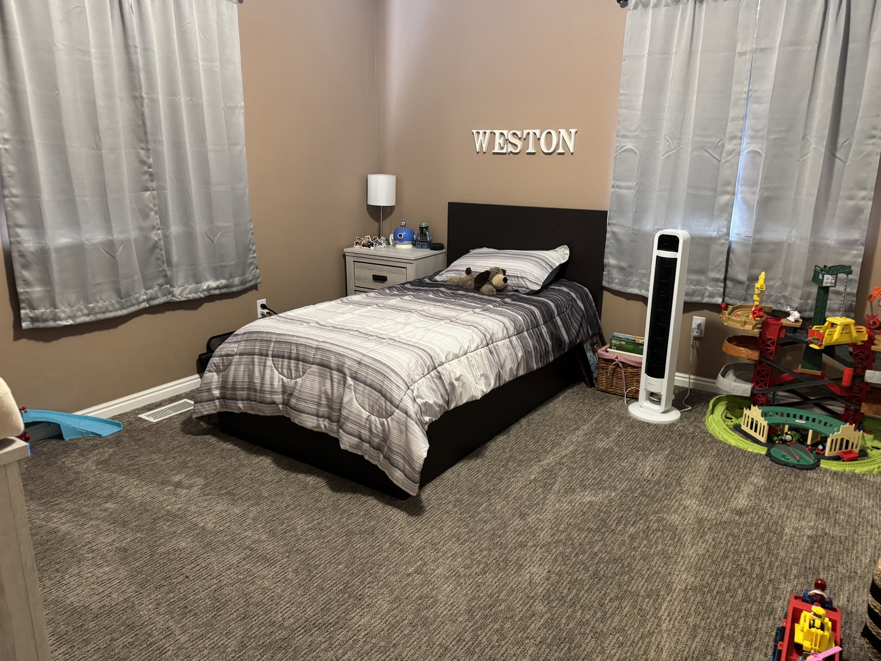 Room featuring neutral-toned carpet flooring and warm-toned wall paint