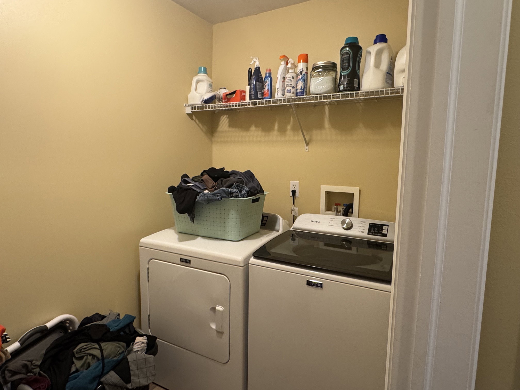 Dedicated laundry area featuring a white wire shelving unit for storage