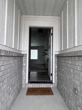 Doorway to property with brick siding