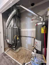 Utility room featuring gas water heater and heating unit