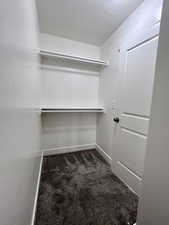 Walk in closet featuring off the primary bathroom