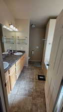 Bathroom with double vanity, a bath, a stall shower, and light tile patterned flooring