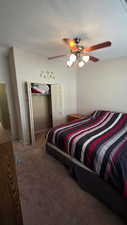 Bedroom with ceiling fan and carpet floors
