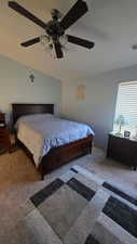 Bedroom featuring carpet flooring, ceiling fan, and lofted ceiling