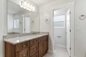 Bathroom with vanity and light tile patterned flooring