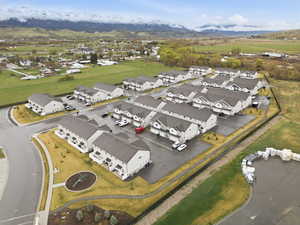 Aerial view of property's location with a mountainous background and nearby suburban area