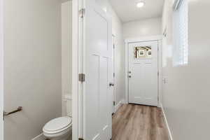 Entryway with wood finished floors and baseboards