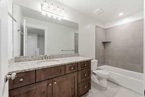 Bathroom featuring vanity, light tile patterned flooring, recessed lighting, and shower / washtub combination