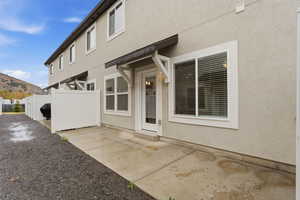 Back of house featuring stucco siding, a patio, and a mountain view