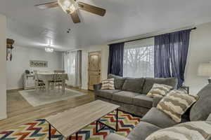 Living area featuring wood finished floors and ceiling fan