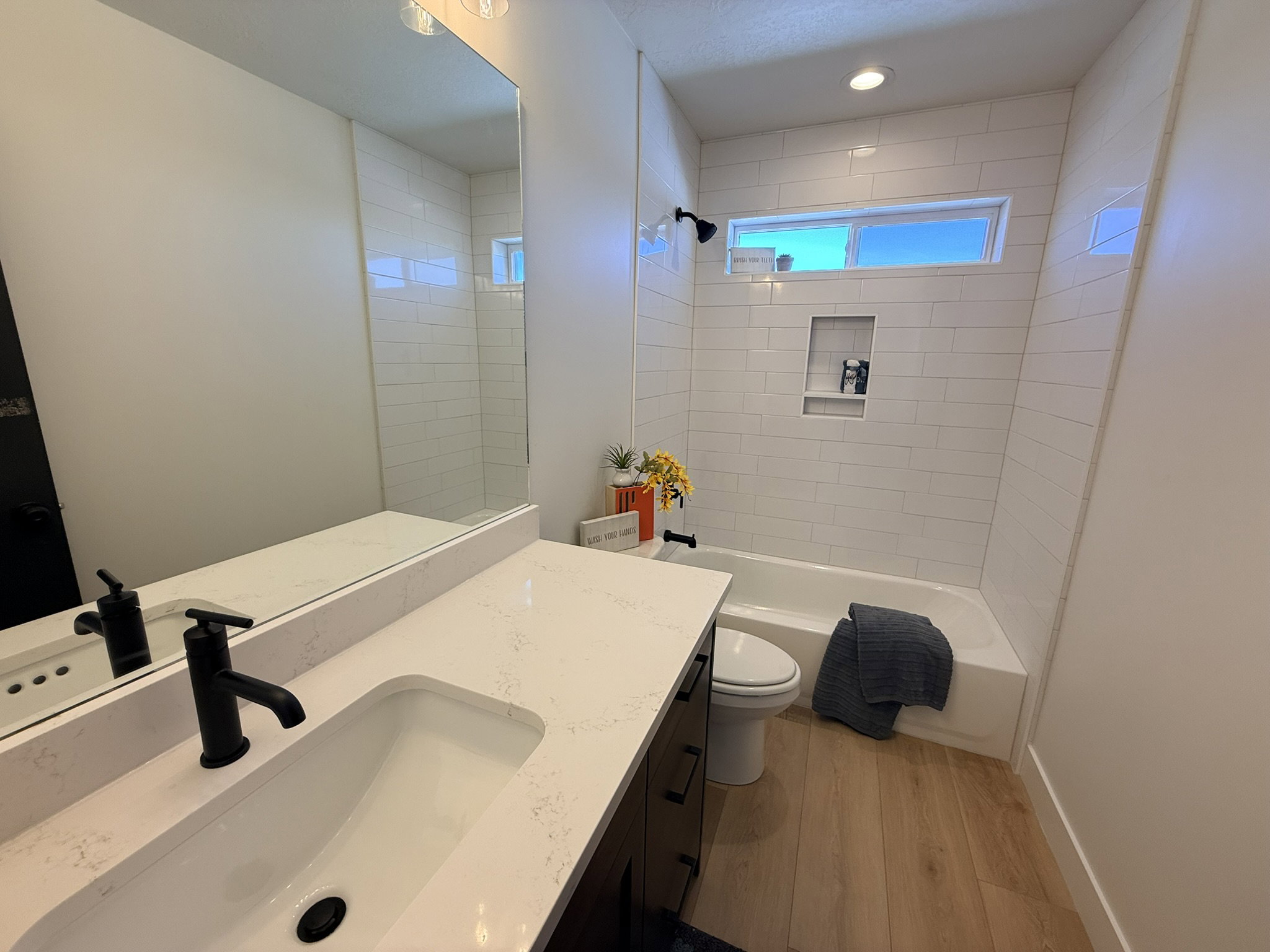 Bathroom featuring vanity, light wood-style flooring, washtub / shower combination, and recessed lighting