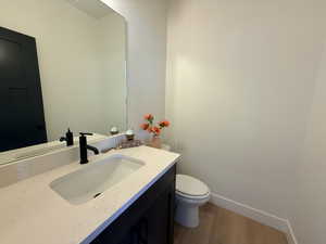 Half bath with vanity and light wood-type flooring