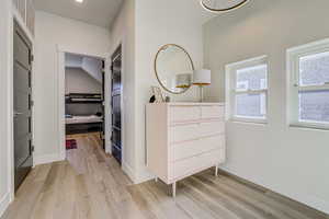Corridor featuring light wood-style flooring