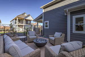 View of patio featuring an outdoor living space with a fire pit