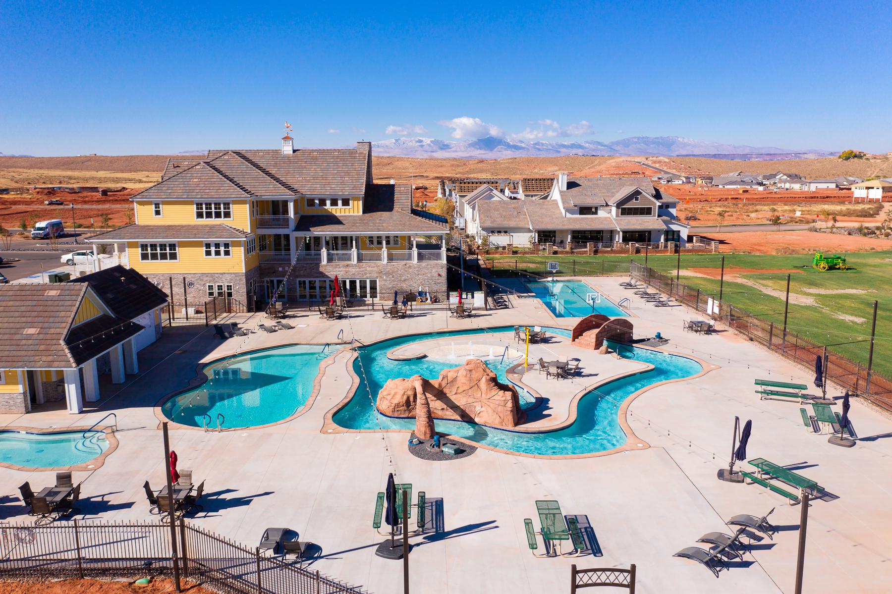 Community pool with a patio area and a residential view