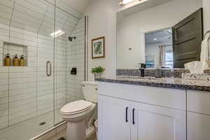 Bathroom featuring vanity and a stall shower