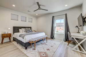 Bedroom with light wood-style flooring, a ceiling fan, and recessed lighting