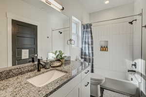 Bathroom with vanity and shower / tub combo with curtain