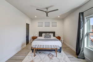 Bedroom featuring light wood finished floors, ceiling fan, and recessed lighting