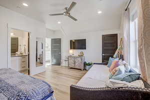 Bedroom with light wood-style floors, recessed lighting, ceiling fan, and ensuite bathroom