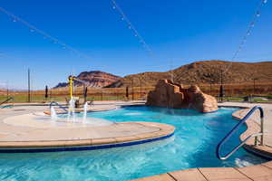 Community pool featuring a mountain view and a patio area