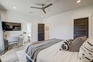 Bedroom with light wood-style floors, recessed lighting, ceiling fan, and an office area