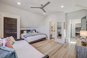 Bedroom featuring light wood-type flooring, ceiling fan, lofted ceiling, and recessed lighting