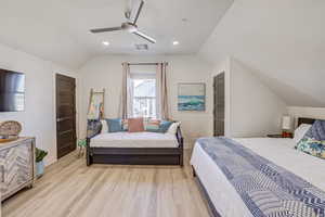 Bedroom featuring vaulted ceiling, light wood-style flooring, ceiling fan, and recessed lighting