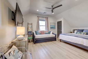 Bedroom featuring lofted ceiling, light wood finished floors, recessed lighting, and a ceiling fan