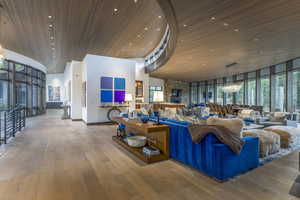 Building lobby featuring floor to ceiling windows and a high wooden ceiling