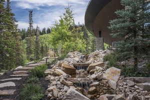 Exterior view of a small pond and stone siding