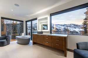 Full bath featuring vanity, a mountain view, and a freestanding bath