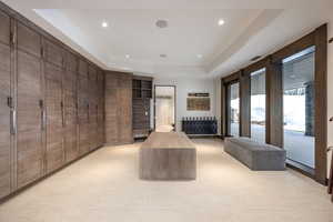 Walk in closet with a raised ceiling