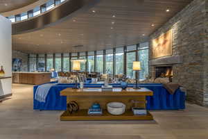 Building lobby featuring a high wooden ceiling, floor to ceiling windows, and recessed lighting