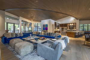 Living area with a vaulted wood ceiling, wood finished floors, and recessed lighting