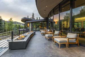 Patio terrace at dusk with an outdoor fire pit and a patio area