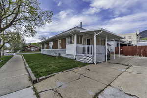 Bungalow-style house featuring a front lawn, driveway, and a porch