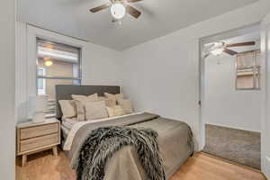 Bedroom with light wood-style flooring and a ceiling fan