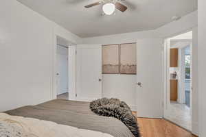 Bedroom with light wood-style flooring and a ceiling fan