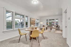 Dining space featuring carpet floors and a textured ceiling
