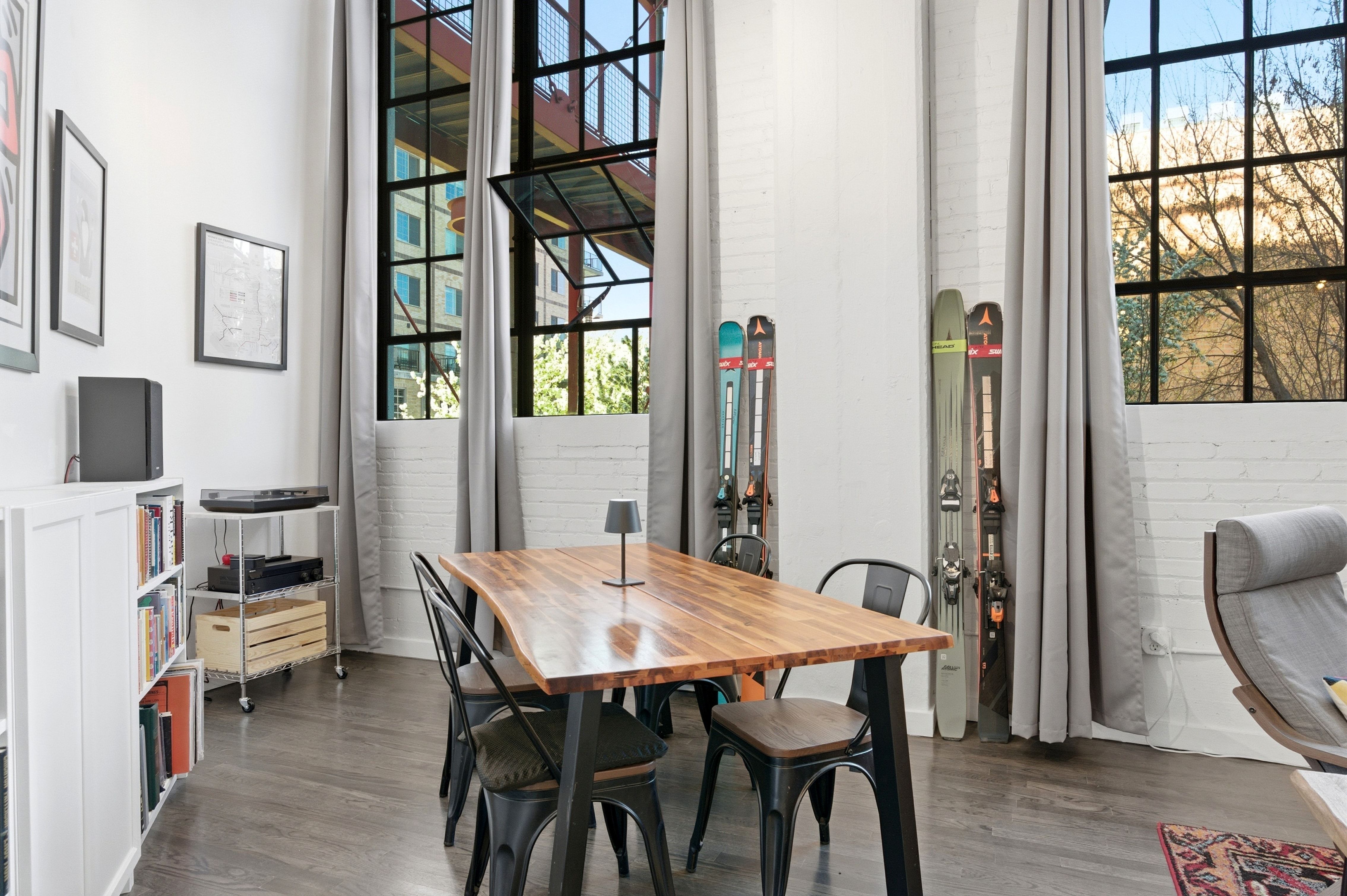 Dining space featuring wood finished floors and a high ceiling