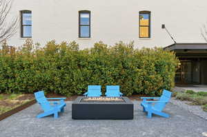 View of patio with an outdoor fire pit