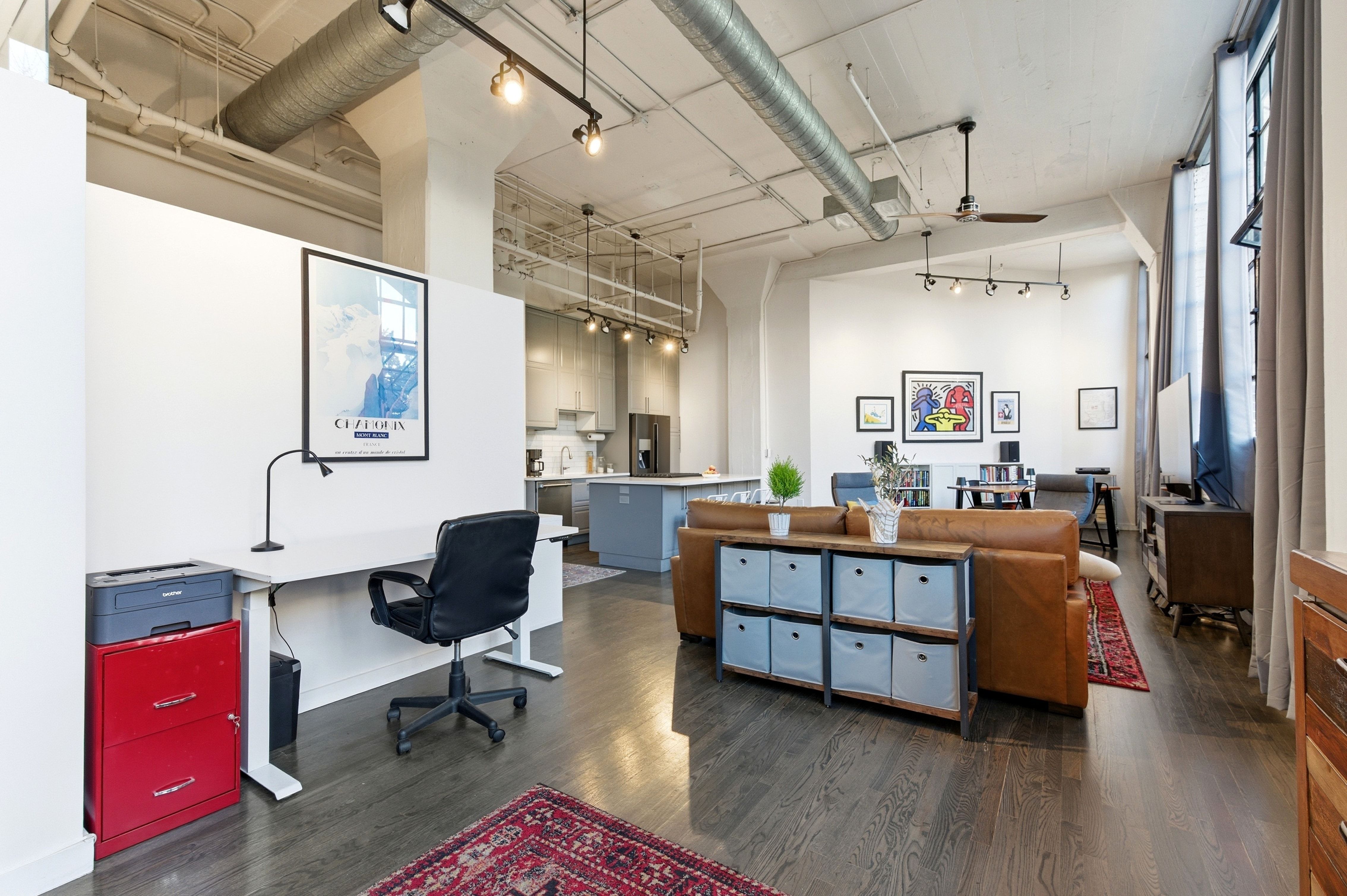 Home office with a ceiling fan, a high ceiling, and rail lighting