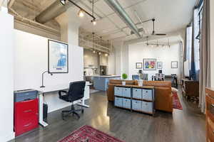 Home office with a ceiling fan, a high ceiling, and rail lighting