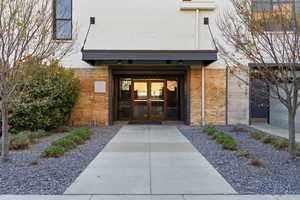 View of exterior entry with french doors and brick siding