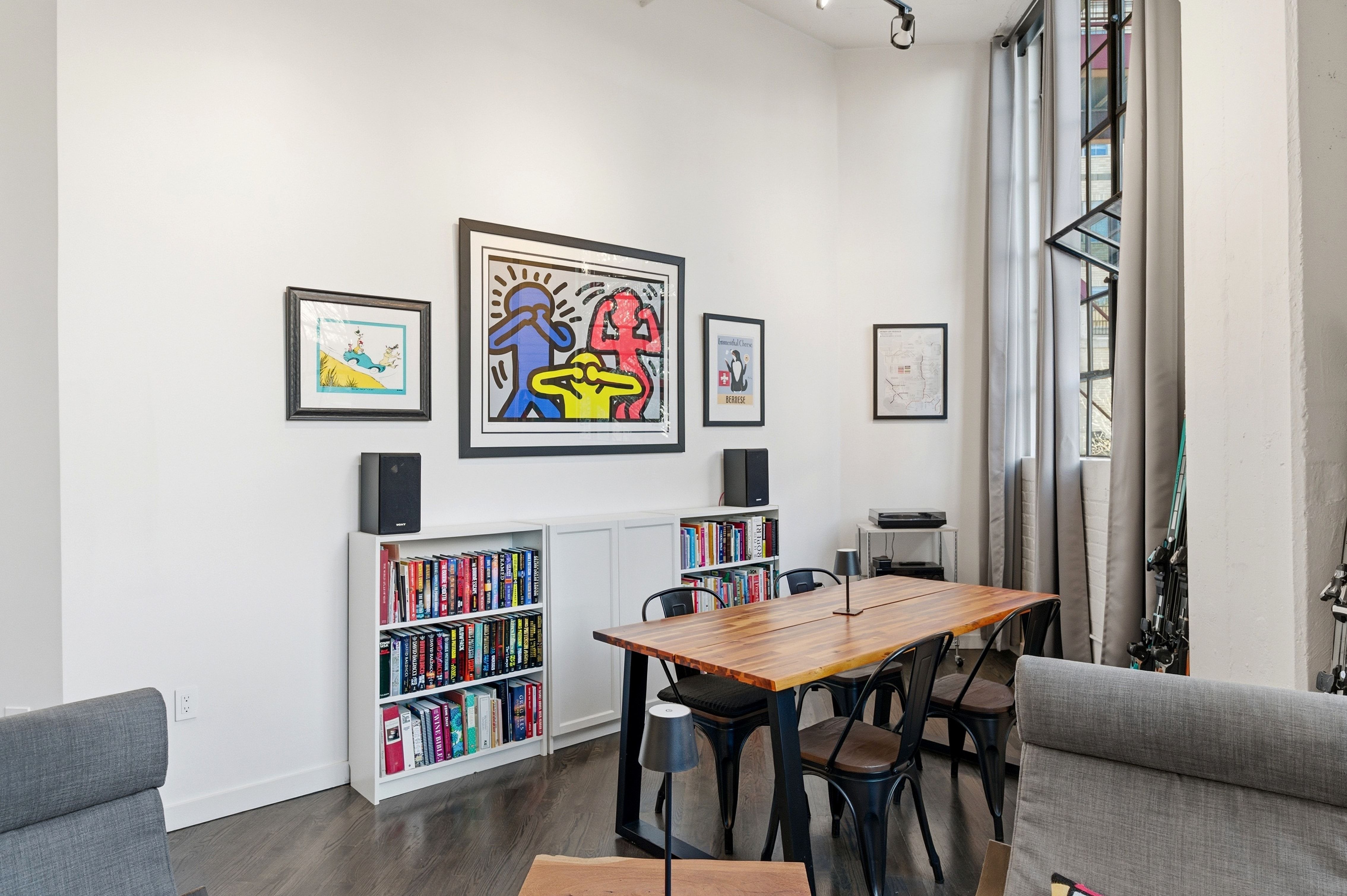 Dining room featuring dark wood-style flooring and baseboards