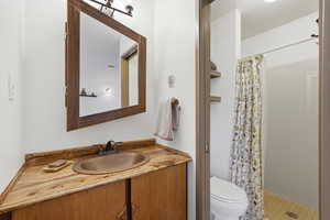 Bathroom featuring vanity and a shower stall