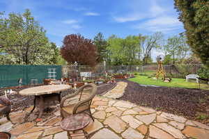 Fenced backyard featuring a patio area and outdoor dining area