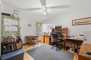 Home office featuring light wood-style floors and a ceiling fan