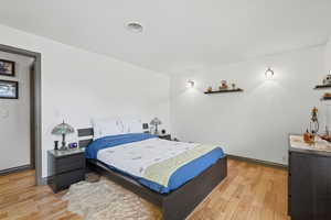 Bedroom featuring light wood-style floors and baseboards